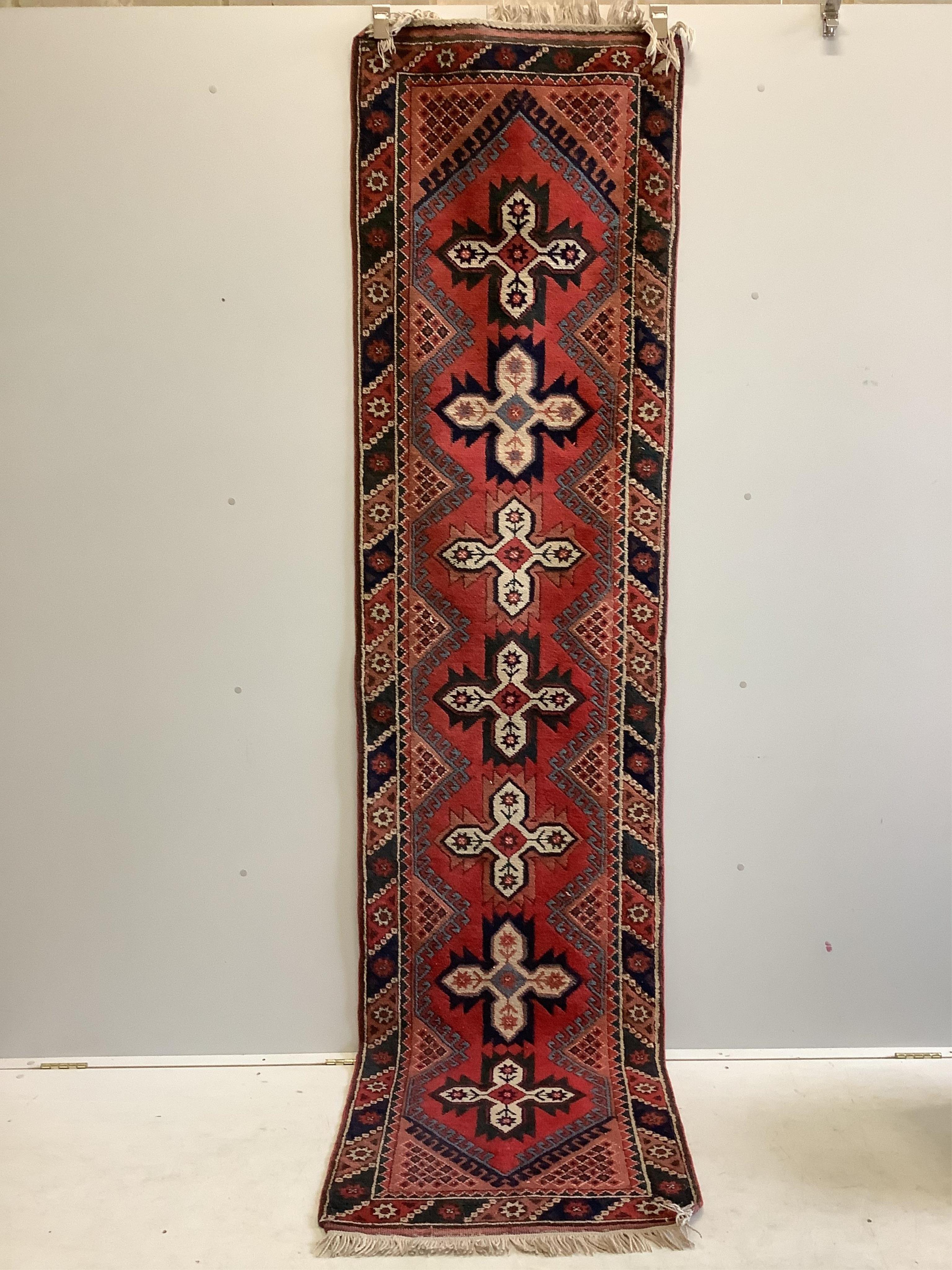 Three Caucasian style red ground runners, largest 290 x 72cm. Condition - fair